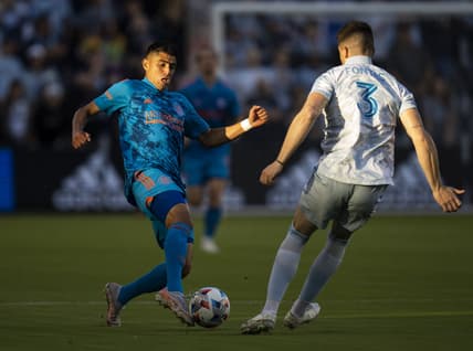 May 29, 2021; Kansas City, Kansas, USA; Houston Dynamo midfielder Joe Corona (14) controls the ball against Sporting Kansas City defender Andreu Fontas (3) during the first half at Children's Mercy Park. Mandatory Credit: Jay Biggerstaff-USA TODAY Sports