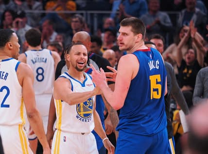 Apr 18, 2022; San Francisco, California, USA; Golden State Warriors guard Stephen Curry (30) and Denver Nuggets center Nikola Jokic (15) in a confrontation as a time out is called during the first quarter of game two of the first round for the 2022 NBA playoffs at Chase Center. Mandatory Credit: Kelley L Cox-USA TODAY Sports