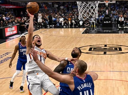 Apr 20, 2023; Los Angeles, California, USA; Phoenix Suns guard Devin Booker (1) drives past Los Angeles Clippers forward Marcus Morris Sr. (8) and center Mason Plumlee (44) for a basket in the first half at Crypto.com Arena. Mandatory Credit: Jayne Kamin-Oncea-USA TODAY Sports