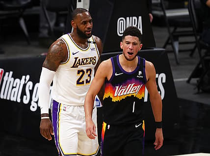May 23, 2021; Phoenix, Arizona, USA; Phoenix Suns guard Devin Booker (1) reacts alongside Los Angeles Lakers forward LeBron James (23) in the first half during game one in the first round of the 2021 NBA Playoffs. at Phoenix Suns Arena. Mandatory Credit: Mark J. Rebilas-USA TODAY Sports