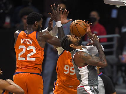 Jun 26, 2021; Los Angeles, California, USA; Los Angeles Clippers guard Paul George (13) drives to the basket against Phoenix Suns center Deandre Ayton (22) and forward Jae Crowder (99) in the first half of game four of the Western Conference Finals for the 2021 NBA Playoffs at Staples Center. Mandatory Credit: Jayne Kamin-Oncea-USA TODAY Sports