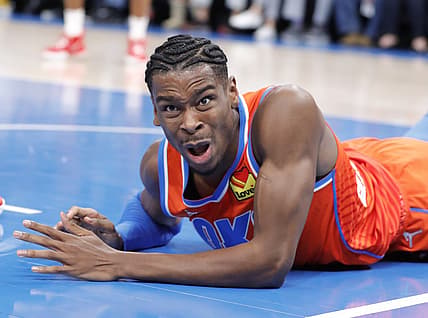 Dec 26, 2021; Oklahoma City, Oklahoma, USA; Oklahoma City Thunder guard Shai Gilgeous-Alexander (2) reacts after getting fouled by New Orleans Pelicans guard Devonte' Graham (4) during the second quarter at Paycom Center. Mandatory Credit: Alonzo Adams-USA TODAY Sports