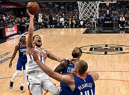 Apr 20, 2023; Los Angeles, California, USA; Phoenix Suns guard Devin Booker (1) drives past Los Angeles Clippers forward Marcus Morris Sr. (8) and center Mason Plumlee (44) for a basket in the first half at Crypto.com Arena. Mandatory Credit: Jayne Kamin-Oncea-USA TODAY Sports