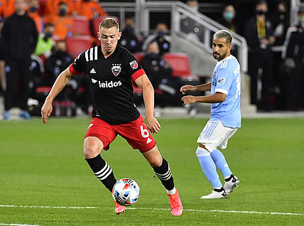 Apr 17, 2021; Washington, DC, Washington, DC, USA; D.C. United midfielder Russell Canouse (6) advances the ball as New York City FC midfielder Valentin Castellanos (11) looks on during the first half at Audi Field. Mandatory Credit: Brad Mills-USA TODAY Sports