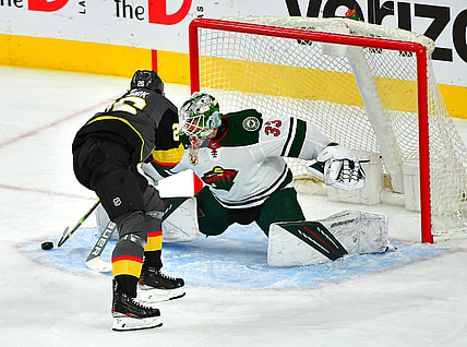 May 28, 2021; Las Vegas, Nevada, USA; Vegas Golden Knights center Mattias Janmark (26) scores a first period goal against Minnesota Wild goaltender Cam Talbot (33) in game seven of the first round of the 2021 Stanley Cup Playoffs at T-Mobile Arena. Mandatory Credit: Stephen R. Sylvanie-USA TODAY Sports