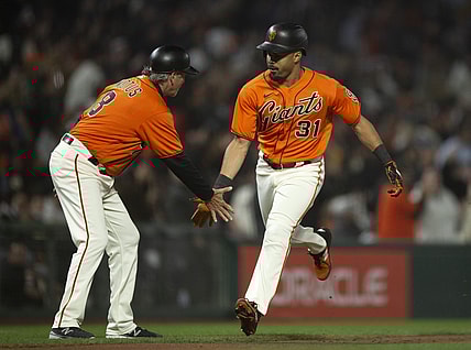 Sep 17, 2021; San Francisco, California, USA; San Francisco Giants right fielder LaMonte Wade Jr. (31) gets a congratulatory handshake from third base coach Ron Wotus (8) after hitting a solo home run against the Atlanta Braves during the fourth inning at Oracle Park. Mandatory Credit: D. Ross Cameron-USA TODAY Sports