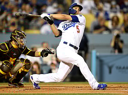 Sep 30, 2021; Los Angeles, California, USA; Los Angeles Dodgers shortstop Corey Seager (5) hits a solo home run in the first inning of the game against the San Diego Padres at Dodger Stadium. Mandatory Credit: Jayne Kamin-Oncea-USA TODAY Sports