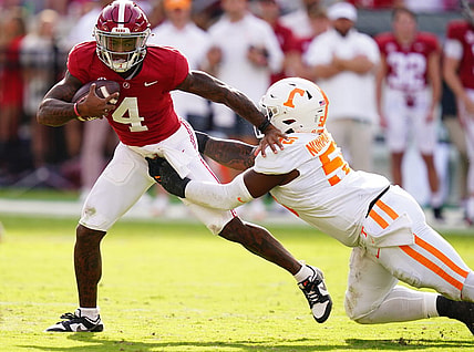 Oct 21, 2023; Tuscaloosa, Alabama, USA; Alabama Crimson Tide quarterback Jalen Milroe (4) gets sacked behind the line of scrimmage by Tennessee Volunteers defensive lineman Omarr Norman-Lott (55) during the first half at Bryant-Denny Stadium. Mandatory Credit: John David Mercer-USA TODAY Sports
