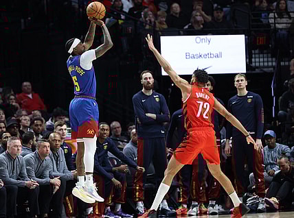 Mar 23, 2024; Portland, Oregon, USA;  Denver Nuggets guard Kentavious Caldwell-Pope (5) shoots the ball over Portland Trail Blazers guard Rayan Rupert (72) in the first quarter at Moda Center. Mandatory Credit: Jaime Valdez-USA TODAY Sports