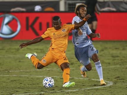 Oct 3, 2020; Houston, Texas, USA; Houston Dynamo forward Darwin Quintero (23) attempts to kick the ball as Sporting Kansas City forward Gianluca Busio (27) defends during the second half at BBVA Stadium. Mandatory Credit: Troy Taormina-USA TODAY Sports