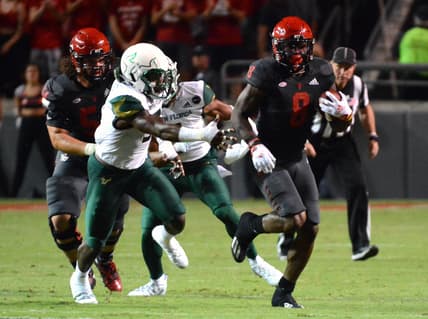 Sep 2, 2021; Raleigh, North Carolina, USA; North Carolina State Wolfpack running back Ricky Person Jr. (8) runs the ball against the South Florida Bulls during the first half at Carter-Finley Stadium. Mandatory Credit: Rob Kinnan-USA TODAY Sports