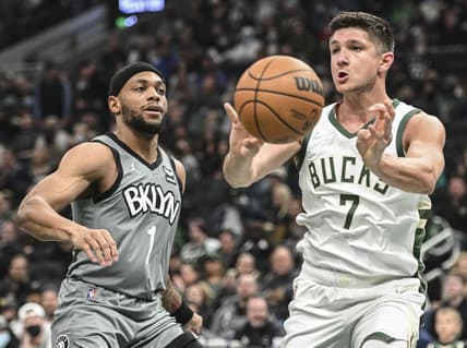Feb 26, 2022; Milwaukee, Wisconsin, USA; Milwaukee Bucks guard Grayson Allen (7) passes the ball away from Brooklyn Nets forward Bruce Brown (1) on the second quarter at Fiserv Forum. Mandatory Credit: Benny Sieu-USA TODAY Sports