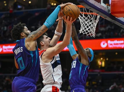Jan 3, 2022; Washington, District of Columbia, USA; Charlotte Hornets forward Miles Bridges (0) blocks the shot of Washington Wizards forward Deni Avdija (9) during the second half at Capital One Arena. Mandatory Credit: Brad Mills-USA TODAY Sports