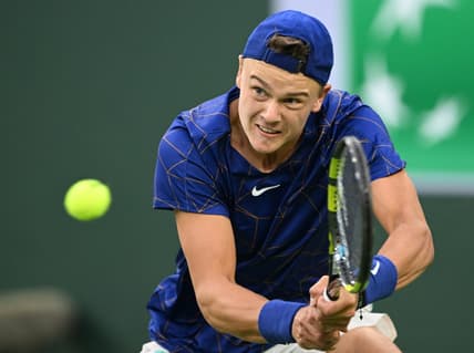 Mar 13, 2022; Indian Wells, CA, USA;  Holger Rune (DEN)  hits a shot against Matteo Berrettini (ITA) during his third round match at the BNP Paribas Open at the Indian Wells Tennis Garden. Mandatory Credit: Jayne Kamin-Oncea-USA TODAY Sports