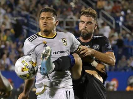 Sep 9, 2022; Montreal, Quebec, CAN; CF Montreal defender Rudy Camacho (4) kicks the ball away from Columbus Crew forward Cucho Suarez (9) during the first half at Stade Saputo. Mandatory Credit: Eric Bolte-USA TODAY Sports
