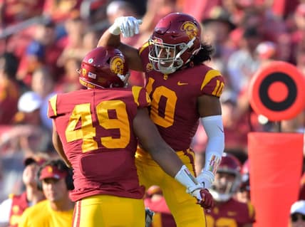 Oct 8, 2022; Los Angeles, California, USA;   USC Trojans defensive lineman Tuli Tuipulotu (49) celebrates with Dlinebacker Ralen Goforth (10) after his second sack on Washington State Cougars quarterback Cameron Ward (1) in the first half at United Airlines Field at Los Angeles Memorial Coliseum. Mandatory Credit: Jayne Kamin-Oncea-USA TODAY Sports