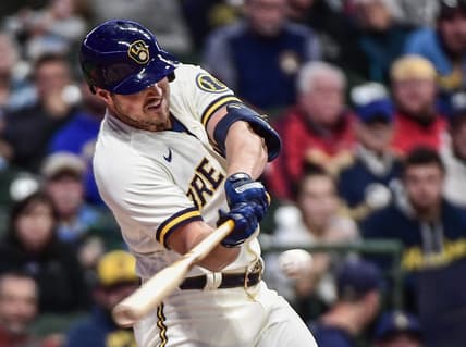Sep 28, 2022; Milwaukee, Wisconsin, USA; Milwaukee Brewers right fielder Hunter Renfroe (12) hits an RBI single in the third inning against the St. Louis Cardinals at American Family Field. Mandatory Credit: Benny Sieu-USA TODAY Sports