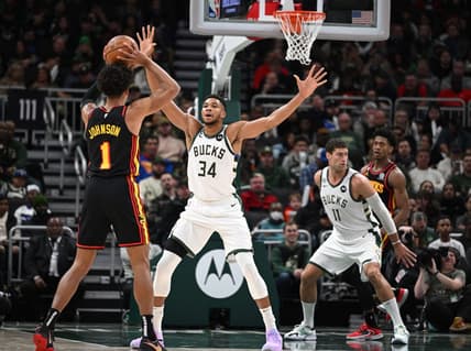 Nov 14, 2022; Milwaukee, Wisconsin, USA; Milwaukee Bucks forward Giannis Antetokounmpo (34) defends against Atlanta Hawks forward Jalen Johnson (1) in the second quarter at Fiserv Forum. Mandatory Credit: Michael McLoone-USA TODAY Sports
