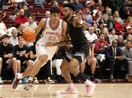 Feb 26, 2023; Stanford, California, USA; Stanford Cardinal forward Brandon Angel (23) drives the baseline past Washington Huskies guard Jamal Bey (5) during the first half at Maples Pavilion. Mandatory Credit: D. Ross Cameron-USA TODAY Sports