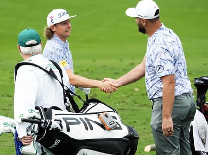 Apr 3, 2023; Augusta, Georgia, USA; Cameron Smith and Jon Rahm shake hands on the practice range during a practice round for The Masters golf tournament at Augusta National Golf Club. Mandatory Credit: Rob Schumacher-USA TODAY Network