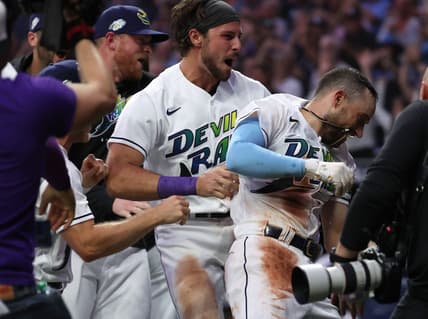 Apr 21, 2023; St. Petersburg, Florida, USA; Tampa Bay Rays second baseman Brandon Lowe (8) celebrates with teammates at home plate as he hits the game winning walk off 2-run home run against the Chicago White Sox at Tropicana Field. Mandatory Credit: Kim Klement-USA TODAY Sports