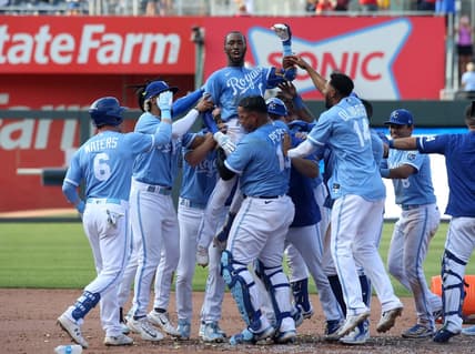 Jun 17, 2023; Kansas City, Missouri, USA; Kansas City Royals left fielder Samad Taylor (0) is lifted in the air by teammate Salvador Perez (13) after Taylor hit the game-winning single in his major league debut against the Los Angeles Angels at Kauffman Stadium. Mandatory Credit: Scott Sewell-USA TODAY Sports
