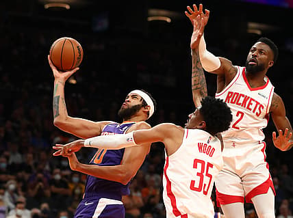 Nov 4, 2021; Phoenix, Arizona, USA; Phoenix Suns center JaVale McGee (00) drives to the basket against Houston Rockets center Christian Wood (35) and forward David Nwaba (2) in the first half at Footprint Center. Mandatory Credit: Mark J. Rebilas-USA TODAY Sports