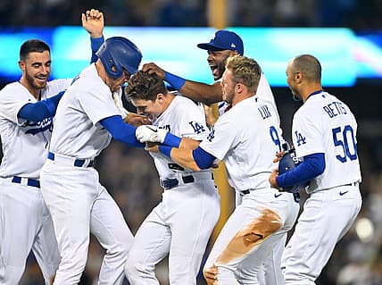 Jul 8, 2022; Los Angeles, California, USA;  Los Angeles Dodgers catcher Will Smith (middle) is mobbed by center fielder Cody Bellinger (35), first baseman Freddie Freeman (5), second baseman Hanser Alberto (17), left fielder Gavin Lux (9) and right fielder Mookie Betts (50) after hitting a walk off RBI single to defeat the Chicago Cubs in the 10th inning at Dodger Stadium. Mandatory Credit: Jayne Kamin-Oncea-USA TODAY Sports