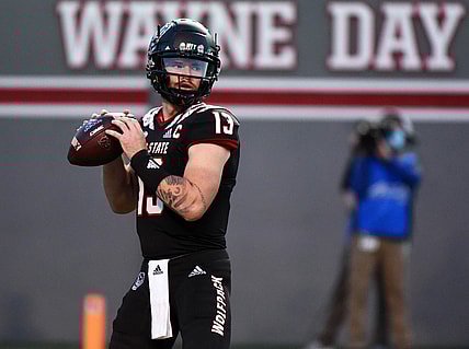 Oct 2, 2021; Raleigh, North Carolina, USA; North Carolina State Wolfpack quarterback Devin Leary (13) drops back to pass against the Louisiana Tech Bulldogs during the first half at Carter-Finley Stadium. Mandatory Credit: Rob Kinnan-USA TODAY Sports