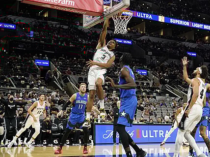 Oct 20, 2021; San Antonio, Texas, USA; San Antonio Spurs forward Keldon Johnson (3) dunks as Orlando Magic center Mo Bamba (5) looks on in the first half at AT&T Center. Mandatory Credit: Scott Wachter-USA TODAY Sports