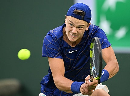 Mar 13, 2022; Indian Wells, CA, USA;  Holger Rune (DEN)  hits a shot against Matteo Berrettini (ITA) during his third round match at the BNP Paribas Open at the Indian Wells Tennis Garden. Mandatory Credit: Jayne Kamin-Oncea-USA TODAY Sports