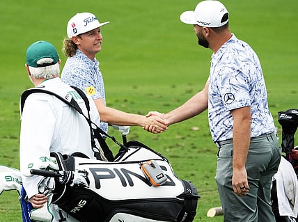 Apr 3, 2023; Augusta, Georgia, USA; Cameron Smith and Jon Rahm shake hands on the practice range during a practice round for The Masters golf tournament at Augusta National Golf Club. Mandatory Credit: Rob Schumacher-USA TODAY Network