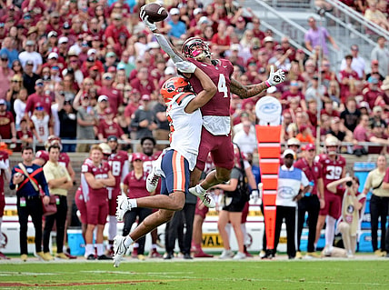 Oct 14, 2023; Tallahassee, Florida, USA; Florida State Seminoles wide receiver Keon Coleman (4) catches a pass over Syracuse Orange defensive back Jason Simmons Jr. (6) during the first quarter at Doak S. Campbell Stadium. Mandatory Credit: Melina Myers-USA TODAY Sports