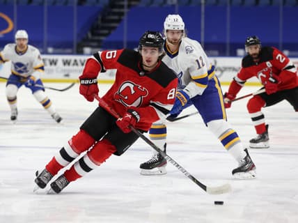 Feb 25, 2021; Buffalo, New York, USA; New Jersey Devils center Jack Hughes (86) looks to make a pass during the first period against the Buffalo Sabres at KeyBank Center. Mandatory Credit: Timothy T. Ludwig-USA TODAY Sports