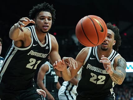 Dec 29, 2022; Indianapolis, Indiana, USA;  Providence Friars forward Clifton Moore (21) and guard Devin Carter (22) chase after a loose ball against the Butler Bulldogs during the first half at Hinkle Fieldhouse. Mandatory Credit: Robert Goddin-USA TODAY Sports