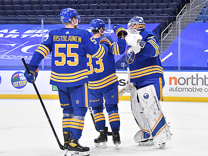 Mar 31, 2021; Buffalo, New York, USA; Buffalo Sabres defenseman Rasmus Ristolainen (55) and defenseman Colin Miller (33) celebrate with goaltender Linus Ullmark (35) after defeating the Philadelphia Flyers at KeyBank Center. Mandatory Credit: Mark Konezny-USA TODAY Sports