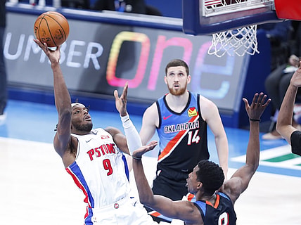 Apr 5, 2021; Oklahoma City, Oklahoma, USA; Detroit Pistons forward Jerami Grant (9) goes to the basket as Oklahoma City Thunder forward Jaylen Hoard (8) defends and guard Svi Mykhailiuk (14) looks on during the second half at Chesapeake Energy Arena. Mandatory Credit: Alonzo Adams-USA TODAY Sports