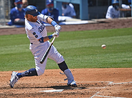 Apr 28, 2021; Los Angeles, California, USA;  Los Angeles Dodgers third baseman Justin Turner (10) as he hits a solo home run in the third inning of the game against the Cincinnati Reds at Dodger Stadium. Mandatory Credit: Jayne Kamin-Oncea-USA TODAY Sports