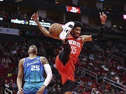 Nov 27, 2021; Houston, Texas, USA; Houston Rockets center Christian Wood (35) dunks the ball as Charlotte Hornets forward P.J. Washington (25) defends during the second quarter at Toyota Center. Mandatory Credit: Troy Taormina-USA TODAY Sports
