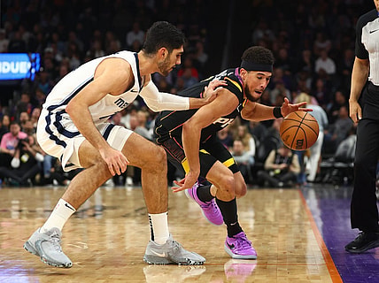 Dec 2, 2023; Phoenix, Arizona, USA; Phoenix Suns guard Devin Booker (right) steals the ball from Memphis Grizzlies forward Santi Aldama in the first half at Footprint Center. Mandatory Credit: Mark J. Rebilas-USA TODAY Sports
