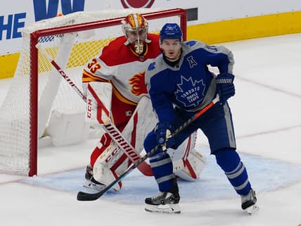 Feb 24, 2021; Toronto, Ontario, CAN; Toronto Maple Leafs forward Zach Hyman (11) screens Calgary Flames goaltender David Rittich (33) during the first period at Scotiabank Arena. Mandatory Credit: John E. Sokolowski-USA TODAY Sports