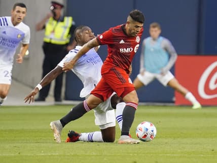 Jul 17, 2021; Toronto, Ontario, USA; Toronto FC midfielder Alejandro Pozuelo (10) gets past an Orlando City player during the first half at BMO Field. Mandatory Credit: John E. Sokolowski-USA TODAY Sports