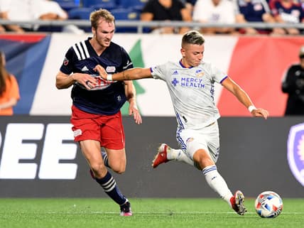 Aug 21, 2021; Foxborough, Massachusetts, USA; FC Cincinnati midfielder Alvaro Barreal (31) attempts a shot in front of New England Revolution defender Henry Kessler (4) during the first half at Gillette Stadium. Mandatory Credit: Brian Fluharty-USA TODAY Sports