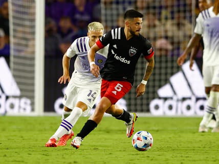 Oct 2, 2021; Orlando, Florida, USA;  D.C. United midfielder Junior Moreno (5) controls the ball past Orlando City forward Silvester van der Water (14) in the second half at Orlando City Stadium. Mandatory Credit: Nathan Ray Seebeck-USA TODAY Sports