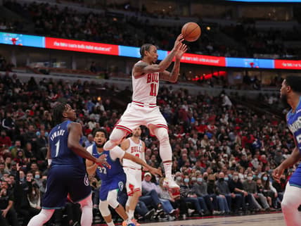 Feb 11, 2022; Chicago, Illinois, USA; Chicago Bulls forward DeMar DeRozan (11) passes with Minnesota Timberwolves forward Anthony Edwards (1) defending during the first half at the United Center. Mandatory Credit: Dennis Wierzbicki-USA TODAY Sports
