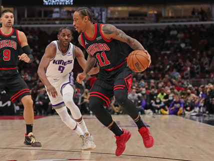 Feb 16, 2022; Chicago, Illinois, USA; Chicago Bulls forward DeMar DeRozan (11) drives past Sacramento Kings guard Justin Holiday (9) during the first quarter at the United Center. Mandatory Credit: Dennis Wierzbicki-USA TODAY Sports