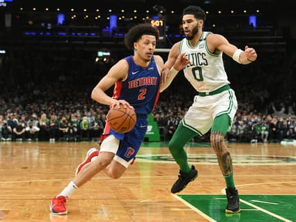 Feb 16, 2022; Boston, Massachusetts, USA; Detroit Pistons guard Cade Cunningham (2) drives to the basket against Boston Celtics forward Jayson Tatum (0) during the first half at the TD Garden. Mandatory Credit: Brian Fluharty-USA TODAY Sports
