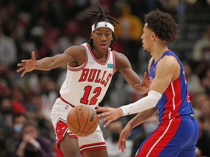 Jan 11, 2022; Chicago, Illinois, USA; Chicago Bulls center Tony Bradley (13) defends Detroit Pistons guard Cade Cunningham (right) during the first half at the United Center. Mandatory Credit: Dennis Wierzbicki-USA TODAY Sports