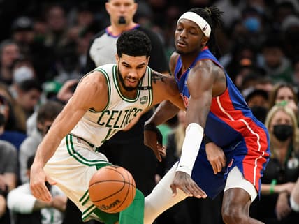 Feb 16, 2022; Boston, Massachusetts, USA; Boston Celtics forward Jayson Tatum (0) and Detroit Pistons forward Jerami Grant (9) reach for a loose ball during the first half at the TD Garden. Mandatory Credit: Brian Fluharty-USA TODAY Sports