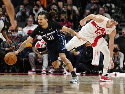 Mar 4, 2022; Toronto, Ontario, CAN; Orlando Magic guard Cole Anthony (50) dribbles past Toronto Raptors forward Yuta Watanabe (18) during the second half at Scotiabank Arena. Mandatory Credit: John E. Sokolowski-USA TODAY Sports